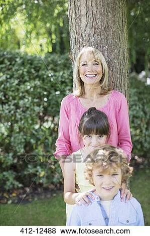 Stock Photo - Grandmother and grandchildren smiling outdoors. Fotosearch