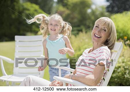 Grandmother and granddaughter in backyard View Large Photo Image Stock Image - Grandmother and granddaughter in backyard. Fotosearch