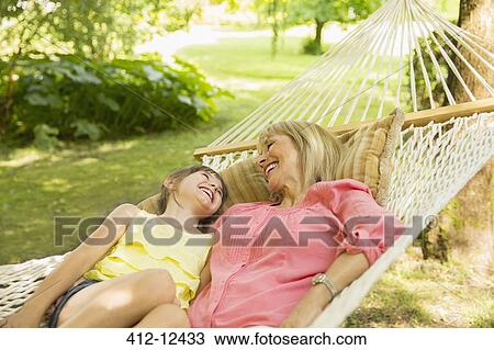 Grandmother and granddaughter relaxing in hammock View Large Photo Image Stock Image - Grandmother and granddaughter relaxing in hammock. Fotosearch
