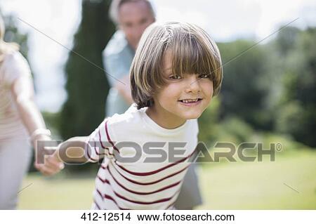 Picture - Grandparents pulling grandparents outdoors. Fotosearch