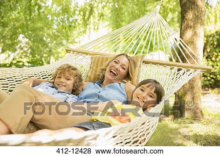Mother and children relaxing in hammock View Large Photo Image Stock Photo - Mother and children relaxing in hammock. Fotosearch