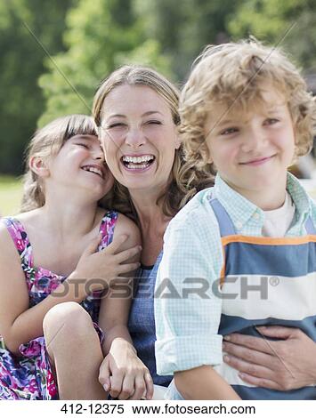 Mother and children smiling outdoors View Large Photo Image Stock Photography - Mother and children smiling outdoors. Fotosearch