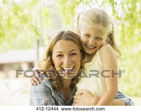 Mother and daughter hugging outdoors View Large Photo Image Picture - Mother and daughter hugging outdoors. Fotosearch