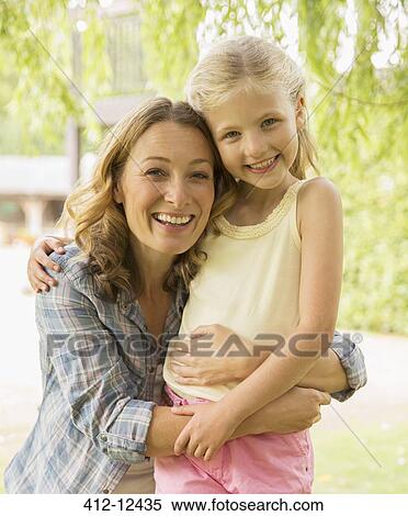 Mother and daughter hugging outdoors View Large Photo Image Stock Photography - Mother and daughter hugging outdoors. Fotosearch