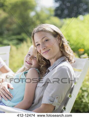 Mother and daughter relaxing in backyard View Large Photo Image Picture - Mother and daughter relaxing in backyard. Fotosearch
