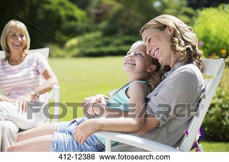 Mother and daughter relaxing in backyard View Large Photo Image Stock Photo - Mother and daughter relaxing in backyard. Fotosearch