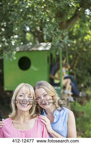 Stock Photo - Mother and daughter smiling outdoors. Fotosearch