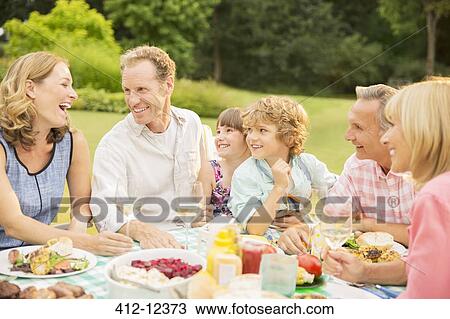 Multi-generation family enjoying lunch in backyard View Large Photo Image Stock Image - Multi-generation family enjoying lunch in backyard. Fotosearch