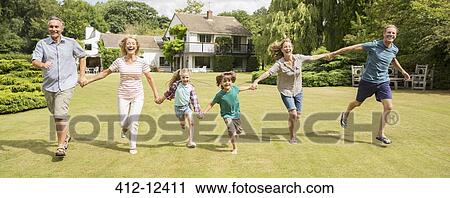 Multi-generation family holding hands and running in grass View Large Photo Image Stock Image - Multi-generation family holding hands and running in grass. Fotosearch