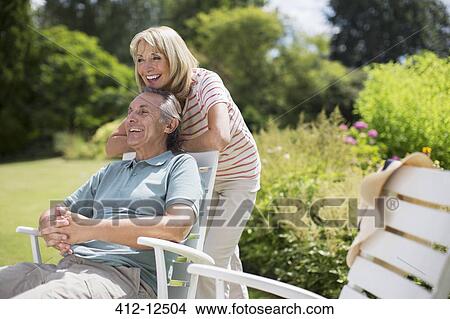 Senior couple relaxing in backyard View Large Photo Image Picture - Senior couple relaxing in backyard. Fotosearch
