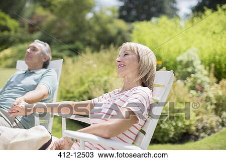 Senior couple relaxing in backyard View Large Photo Image Stock Image - Senior couple relaxing in backyard. Fotosearch