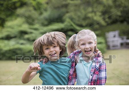 Smiling children hugging outdoors View Large Photo Image Stock Photograph - Smiling children hugging outdoors. Fotosearch