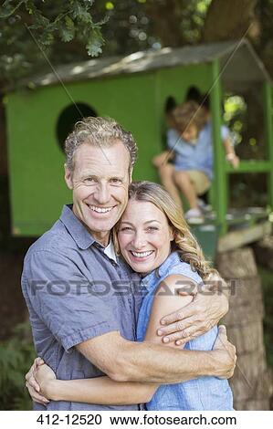 Smiling couple hugging outdoors View Large Photo Image Stock Image - Smiling couple hugging outdoors. Fotosearch