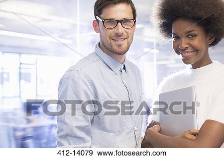 Stock Photo - Business people smiling in office. Fotosearch