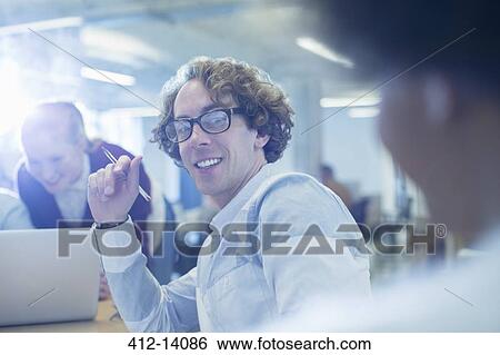 Businessman smiling in office View Large Photo Image Stock Photograph - Businessman smiling in office. Fotosearch