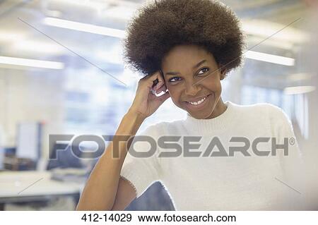 Stock Photo - Businesswoman smiling in office. Fotosearch