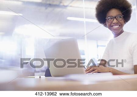 Businesswoman working on laptop in office View Large Photo Image Stock Image - Businesswoman working on laptop in office. Fotosearch