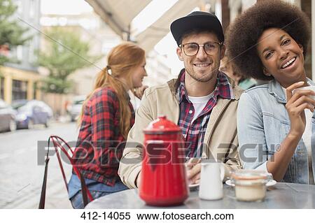 Stock Photography - Couple drinking coffee at sidewalk cafe. Fotosearch