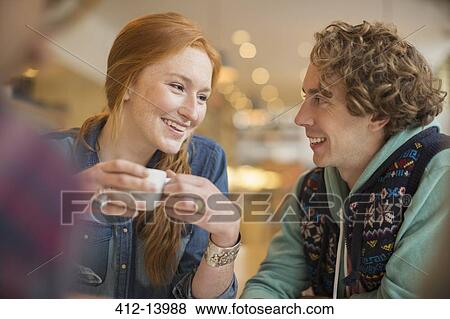 Couple drinking coffee in cafe View Large Photo Image Stock Photo - Couple drinking coffee in cafe. Fotosearch
