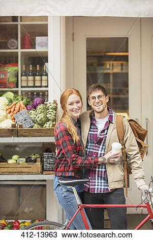 Stock Image - Couple hugging on city street. Fotosearch