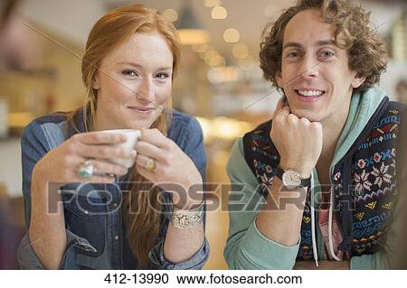 Stock Image - Couple smiling together in cafe. Fotosearch