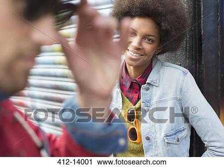 Stock Image - Couple talking on city street. Fotosearch