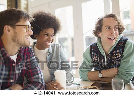 Friends enjoying coffee in cafe View Large Photo Image Stock Image - Friends enjoying coffee in cafe. Fotosearch
