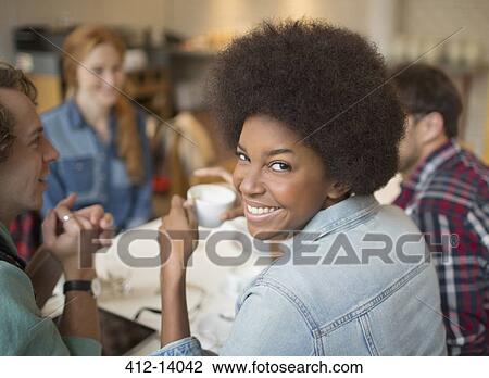 Friends enjoying coffee in cafe View Large Photo Image Stock Image - Friends enjoying coffee in cafe. Fotosearch