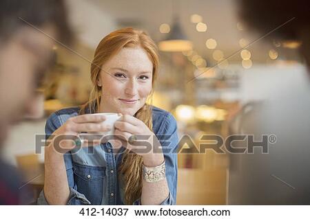 Stock Photo - Friends enjoying coffee in cafe. Fotosearch