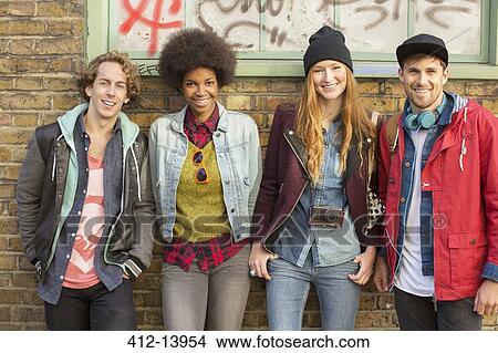 Picture - Friends smiling together on city street. Fotosearch