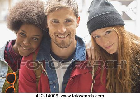 Stock Photograph - Friends smiling together outdoors. Fotosearch