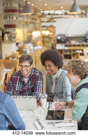Stock Photo - Friends talking in cafe. Fotosearch