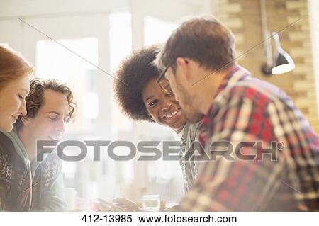 Stock Photography - Friends talking in cafe. Fotosearch