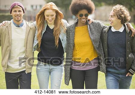 Friends walking together in park View Large Photo Image Stock Image - Friends walking together in park. Fotosearch