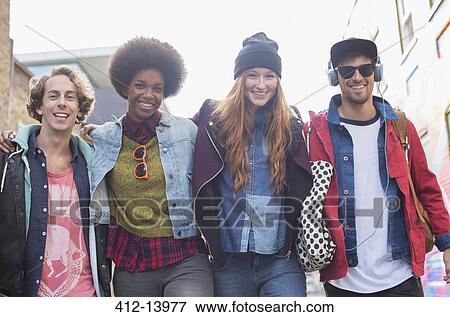 Stock Photo - Friends walking together on city street. Fotosearch