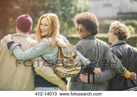 Stock Image - Friends walking together outdoors. Fotosearch