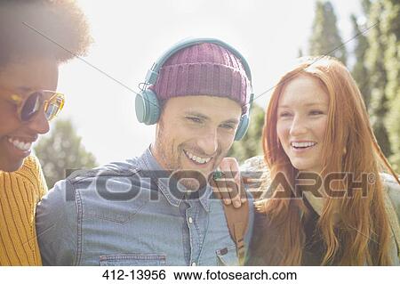 Friends walking together outdoors View Large Photo Image Stock Photograph - Friends walking together outdoors. Fotosearch