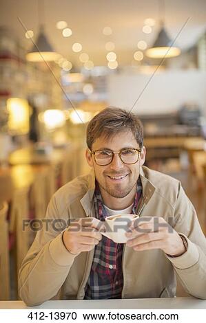 Man drinking coffee in cafe View Large Photo Image Stock Image - Man drinking coffee in cafe. Fotosearch