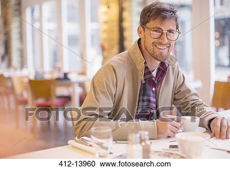 Man enjoying cup of coffee in cafe View Large Photo Image Stock Image - Man enjoying cup of coffee in cafe. Fotosearch