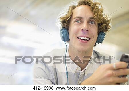 Man listening to headphones View Large Photo Image Stock Photo - Man listening to headphones. Fotosearch