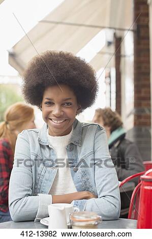 Woman drinking cup of coffee at sidewalk cafe View Large Photo Image Stock Image - Woman drinking cup of coffee at sidewalk cafe. Fotosearch