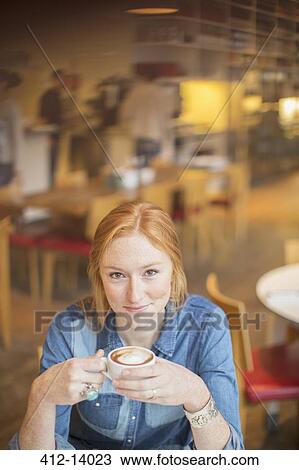 Woman drinking cup of coffee in cafe View Large Photo Image Stock Image - Woman drinking cup of coffee in cafe. Fotosearch