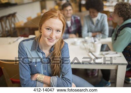 Woman sitting with friends in cafe View Large Photo Image Stock Photo - Woman sitting with friends in cafe. Fotosearch