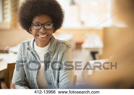 Woman smiling in cafe View Large Photo Image Stock Photograph - Woman smiling in cafe. Fotosearch