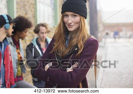 Woman smiling on city street View Large Photo Image Stock Image - Woman smiling on city street. Fotosearch