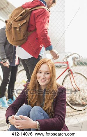 Stock Photograph - Woman smiling on city street. Fotosearch