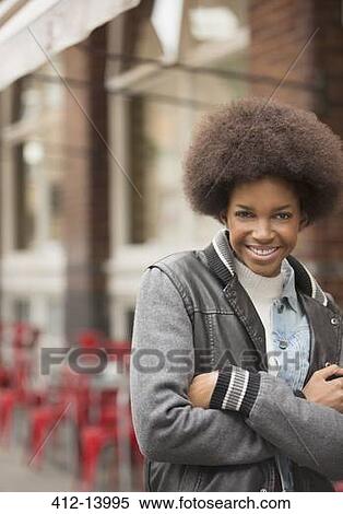 Woman smiling on city street View Large Photo Image Stock Photography - Woman smiling on city street. Fotosearch