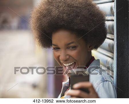 Woman taking self-portrait with cell phone outdoors View Large Photo Image Stock Image - Woman taking self-portrait with cell phone outdoors. Fotosearch