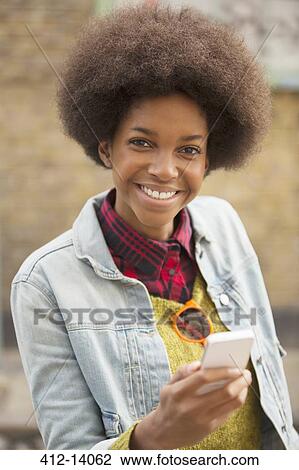 Woman using cell phone outdoors View Large Photo Image Stock Image - Woman using cell phone outdoors. Fotosearch