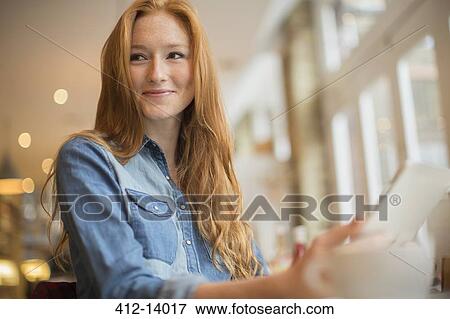 Woman using digital tablet in cafe View Large Photo Image Stock Photo - Woman using digital tablet in cafe. Fotosearch